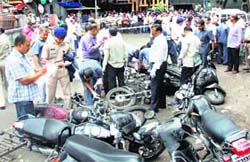 Police inspect the spot after a blast in Pune on Thursday
