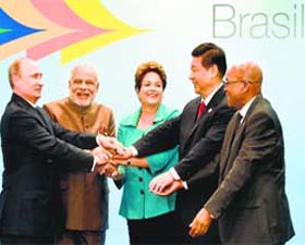 From left: Russia's President Vladimir Putin, India's Prime Minister Narendra Modi, Brazilian President Dilma Rousseff, China's President Xi Jinping and South Africa's President Jacob Zuma join their hands during BRICS Summit in Fortaleza, Brazil, on Tuesday