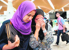 Grieving relatives of passengers on board the ill-fated Malaysia Airlines flight at Kuala Lumpur airport on Friday.