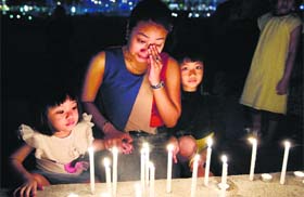 A woman during a candlelight vigil for passengers killed on flight MH-17, in Klang valley, Malaysia on Saturday