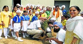 tudents and teachers of Guru Nanak Public School plant a sapling to mark Vanamahotsava in Ludhiana