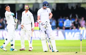 Mahendra Singh Dhoni (L) and Shikhar Dhawan rejoice after a dismissal of an England player during the second Test against England at Lord's