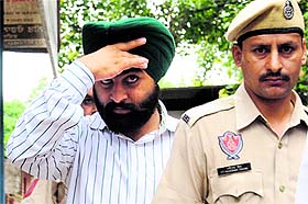SAD leader Harjinder Singh, an accused in the land grab case, being produced at the District Courts in Mohali on Wednesday