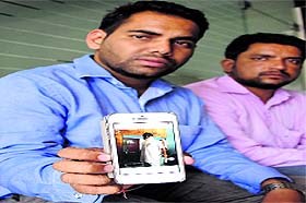 Ravneet Singh, son of Mohinder Singh (one of the accused in the case), shows a picture of his father