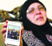A relative of a Lebanese passenger aboard the ill-fated plane shows her picture.