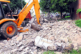 A stitch in time: An unsafe bus queue shelter being razed in Sector 27, Chandigarh, on Saturday