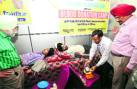 Volunteers donate blood at a camp organised by the Rotary Club in the Industrial Area, Phase II, Mohali, on Saturday.