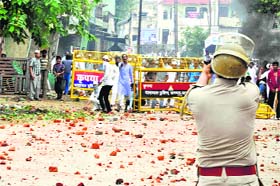 A policeman fires a teargas shell at protesters