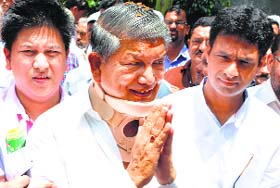 Uttarakhand CM Harish Rawat greets supporters after his victory in Assembly byelections