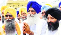 HSGMC president Jagdish Singh Jhinda (C) along with his team members pays obeisance at the Golden Temple in Amritsar on Monday. Tribune photo