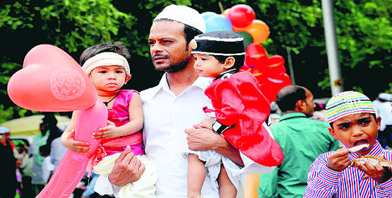 A father holds his children after attending the Eid-ul-Fitr celebrations at Jama Masjid, Sector 20, Chandigarh, on Tuesday.