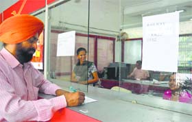 An employee works at a railway reservation counter at the Head Post Office in Ludhiana