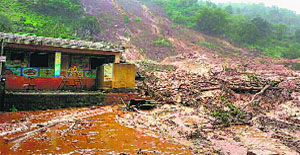 A mudslide after heavy rains burried houses at Malin village in Pune district on Wednesday.