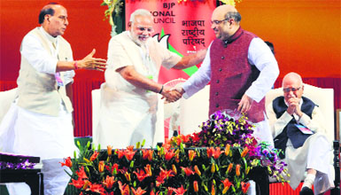 Prime Minister Narendra Modi and Home Minister Rajnath Singh greet BJP president Amit Shah as veteran leader LK Advani (R) looks on during the BJP National Council meeting at Jawaharlal Nehru Stadium in New Delhi on Saturday.