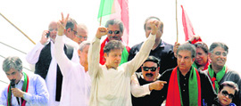 Imran Khan (C) gestures as he begins his anti-govt rally from Lahore on Thursday.