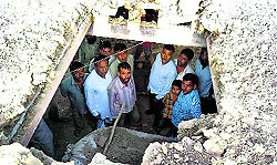 The damaged roof of a house after it was hit by a mortar at Korotana Khurd village in Jammu