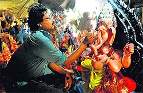 An artist gives the final touches to an idol ahead of Ganesh Chaturthi in Chandigarh.
