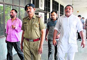 Former cricketer Yograj Singh (right) and Bhupinder being produced in a court in Panchkula on Monday.