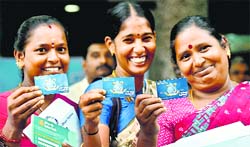 Women beneficiaries display their RuPay debit cards made under Jan Dhan Yojana in Chennai on Thursday.