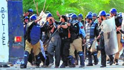 TURMOIL DEEPENS: The police arrest a supporter of cleric Tahir ul-Qadri following clashes near the PM residence in Islamabad on Sunday.