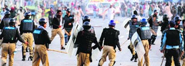 Protesters demanding the ouster of Prime Minister Nawaz Sharif clash with the police near Parliament in Islamabad on Monday. Reuters