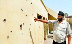 A file photo of a villager showing bullet marks on the wall of his house after firing from the Pakistan side in RS Pura.
