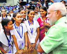 Prime Minister Narendra Modi talks to school students after addressing them on Teachers Day in New Delhi on Friday