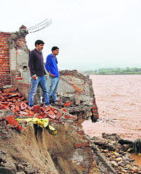 Debris of a house that was damaged by floods on the banks of the Tawi in Jammu on Friday