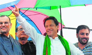 Imran Khan gestures to supporters during the protest near the PM’s residence on Friday. He has emerged a hero among the middle class, though he is now left with no face-saving exit. AFP