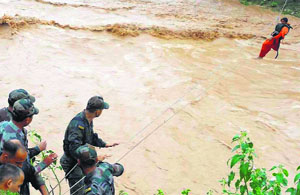 A woman being rescued with a rope by the Army at Kanali Tibba village in Jammu