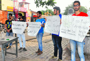 Holding posters, students from Srinagar appeal to residents to donate for the J&K flood-hit, at Sector 20 in Chandigarh on Thursday.