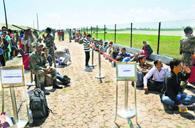 Passengers at Srinagar airport await an IAF flight bound for Jammu on Thursday