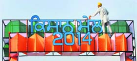 A worker decorates the entrance gate of the venue of the Kisan Mela on the eve of the fair’s inauguration at the PAU in Ludhiana on Thursday