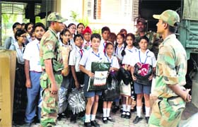 Students of BCM School hand over relief material to Army personnel in Ludhiana on Thursday