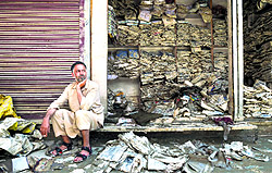 A man near his flood-damaged garment shop at the Lal Chowk area in Srinagar on Wednesday