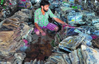 A store employee sorts stock at a garment shop in Srinagar.