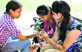 gearing up for festivities: Students of the Government College for Girls prepare themselves for the youth festival, which will start on Tuesday.