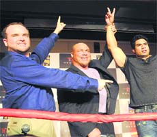 Strong hold: Kurt Angle (centre) and Mahabali Shera (right)