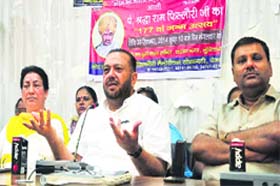Krishan Kumar Bawa (centre), chairman of Pandit Shradha Ram Phillauri Memorial Welfare Society, addresses a press conference