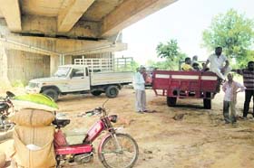 Vegetable vendors wait for officials to go to the site where the subzi mandi is held in BRS Nagar on Sunday