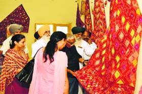Visitors have a look at phulkaris exhibited at the Bhutta College of Technology near Mandi Ahmedgarh on Sunday
