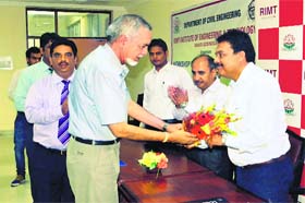 RIMT founder chairman Hukam Chand Bansal (with beard) presents a bouquet to an official of JK Company during a workshop at RIMT Institutes, Mandi Gobindgarh