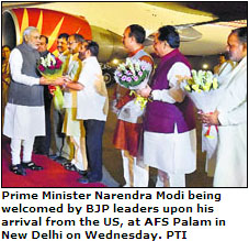Prime Minister Narendra Modi being welcomed by BJP leaders upon his arrival from the US, at AFS Palam in New Delhi on Wednesday. PTI