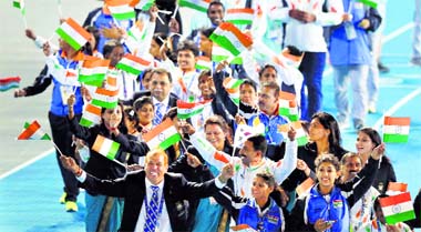 see you in Jakarta: Indian athletes wave national flags as they enter the arena during the closing ceremony of the 2014 Asian Games at Incheon, South Korea, on Saturday. India finished eighth on the medal tally.