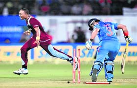 Caribbean onslaught: West Indies captain Dwayne Bravo celebrates after the dismissal of Suresh Raina during the first ODI in Kochi on Wednesday