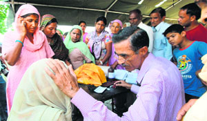 Villagers receive medical aid at a border migrant camp at Deoli village in Jammu on Thursday.
