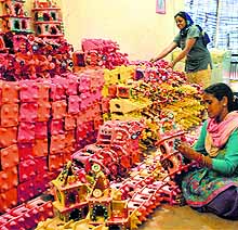 Artists give the final touches to earthen huts in Ludhiana
