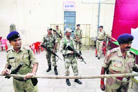 Policemen stand guard at a counting centre in Mumbai