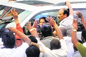 Supporters wave to J Jayalalithaa as she leaves Bangalore jail