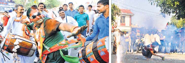 Victory dance: BJP supporters celebrate the win of BJP Karnal candidate Manohar Lal Khattar with the beat of the ‘dhol’ and by bursting crackers in Karnal on Sunday